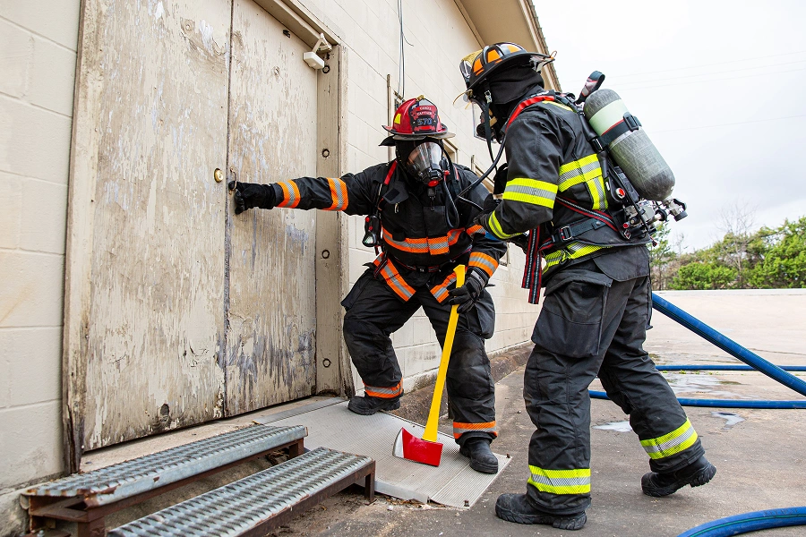 Firefighters at door with equipment